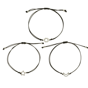 Detail of three woven bracelets with sun star and moon metal charms on black cord