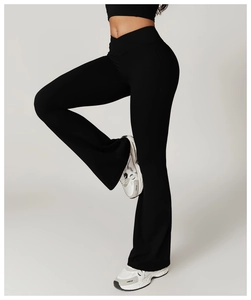 Detail of high-waisted flared yoga pants with V-shaped crossover waistband in black