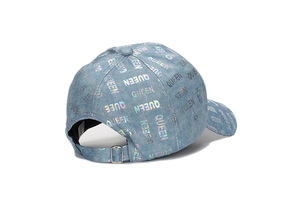 Detail of light blue denim baseball cap with holographic rainbow Queen lettering and buckle