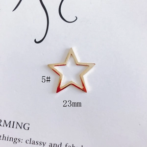 Detailed view of a 23mm golden hollow star charm for DIY jewelry making and earrings