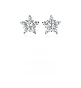 Macro shot of 925 silver snowflake earrings with brilliant sparkling moissanite stones
