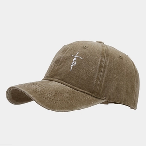 Close-up of faith embroidery and cross design on vintage brown washed cotton cap