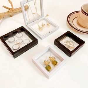 Black and white PE film floating jewelry display boxes with necklaces and rings