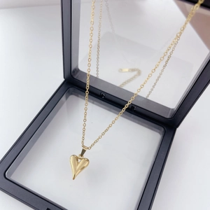 Close-up of golden heart pendant necklace displayed in a black 3D floating jewelry box
