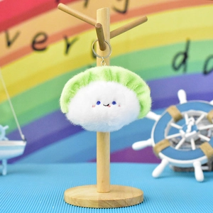 Close-up of a cute plush sushi-shaped keychain with a tiny smiling face detail