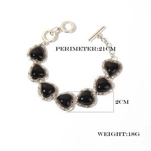Detailed view of retro silver heart bracelet with black stones and toggle clasp closure