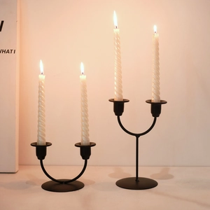 Minimalist black metal U-shaped candle holder set with elegant white spiral candles