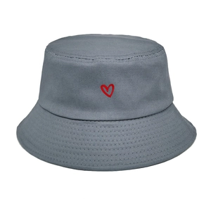 Detail view of red heart embroidery on dark grey cotton bucket hat with fine stitching