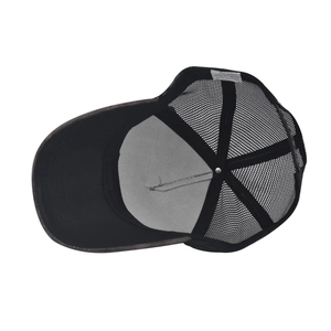 Detailed interior of a black mesh trucker hat showing inner stitching and care label
