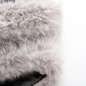 Close-up of grey faux fur texture showing soft plush fibers and fluffy material details