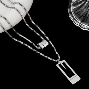 Detail of silver titanium steel double-layer necklace with geometric rectangular pendant