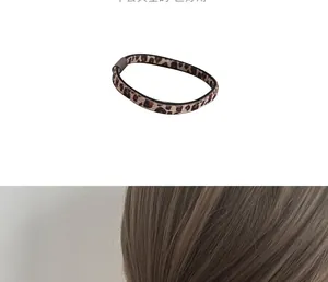 Close-up of seamless leopard print hair tie showing elastic texture and brown buckle