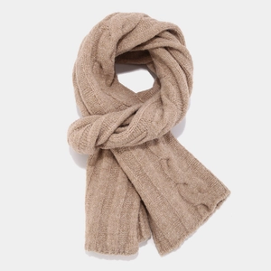 Detail of cable knit texture on thick khaki winter scarf showing premium weave