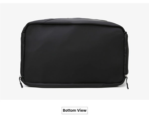 Detailed bottom view of a black waterproof nylon travel bag with metal zippers