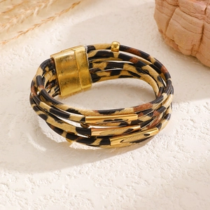 Detail of bohemian leopard print leather bracelet with gold magnetic metal clasp