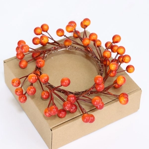 Macro detail of natural orange berry wreath with realistic gradient finish and brown stems