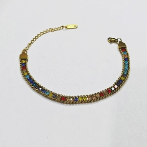 Macro detail of gold stainless steel bracelet with colorful rhinestones and lobster clasp