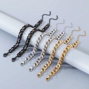 Detail of layered Cuban link bracelets in gold, silver and black with lobster clasp