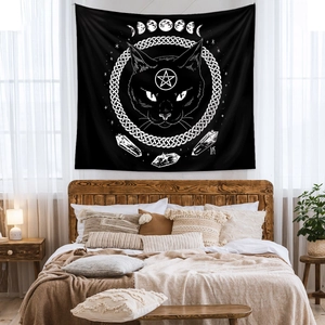 Detail of black mystical cat tapestry with moon phases and celtic knot wall hanging