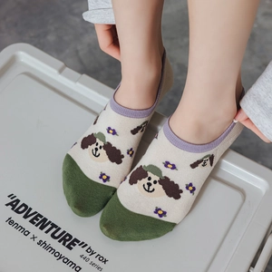 Close-up of low cut invisible socks with cute cartoon puppy and floral patterns