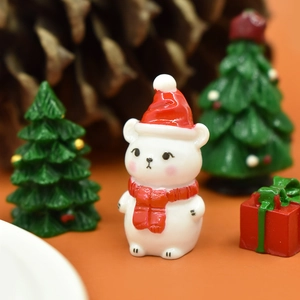 Detailed view of cute Christmas bear resin ornament with Santa hat and festive decor