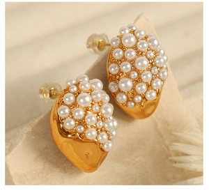 Detail of 18K gold irregular lava stud earrings with micro-pave white faux pearls