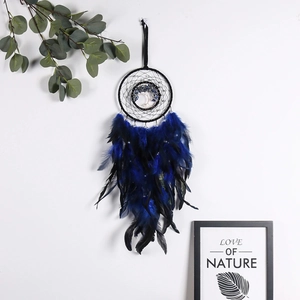 Detail of tree of life dreamcatcher with deep blue feathers and beads wall decor