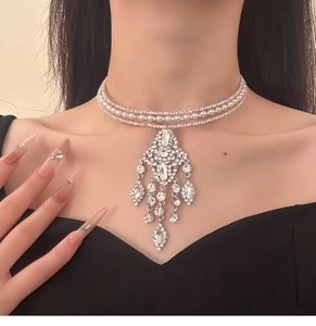 Detailed view of layered silver choker with tassels, white pearls and sparkling rhinestones