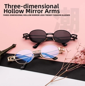 Detail view of steampunk oval sunglasses and blue light glasses with hollow metal temples