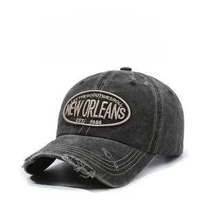 Close-up of distressed brim and New Orleans embroidery on washed denim baseball cap