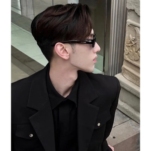 Chic black square frame sunglasses worn by man in stylish black suit for urban street look