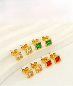Macro shot of assorted colorful square zircon earrings set in vintage gold plating