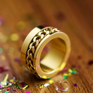 Gold plated stainless steel Cuban link chain ring for men and women on wood surface