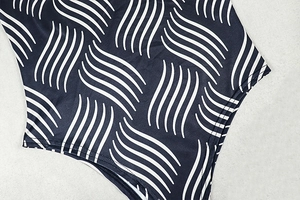 Close-up of black and white wavy geometric patterns on elastic knitted sports fabric