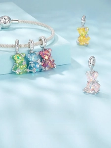 Detailed close-up of S925 silver colorful bear charms on a silver snake bone bracelet