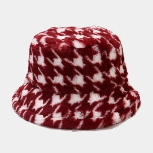 Close-up of plush red and white houndstooth bucket hat with soft faux fur texture