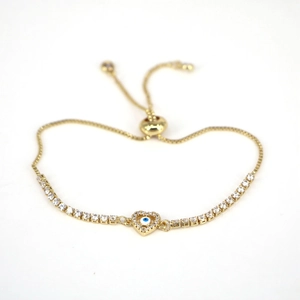 Detailed macro view of heart-shaped evil eye pendant with white zircon in gold finish
