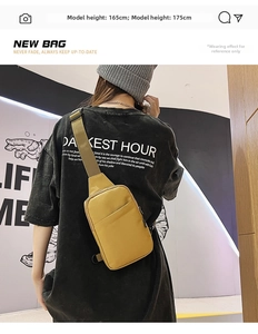 Detail view of a bright yellow chest bag with black adjustable strap worn by a model