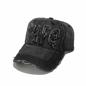 Macro detail of LIFE letter embroidery and distressed denim texture on the baseball cap