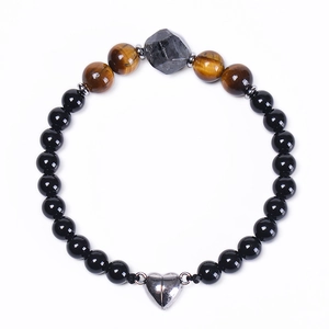 Detail of beaded bracelet showing tiger eye stones and heart-shaped magnetic clasp