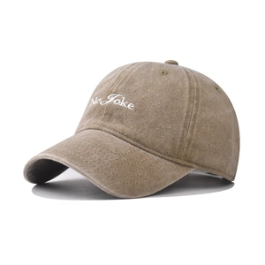 Detail of No Joke embroidery on a vintage washed cotton baseball cap in khaki