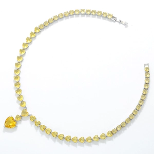 Macro shot of yellow heart-shaped zircon necklace with silver-tone metal settings
