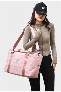 Close-up of pink quilted yoga bag featuring water-resistant fabric and adjustable shoulder strap