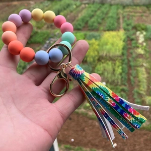 Colorful silicone bead bracelet keychain with vibrant tie-dye tassel and gold metal clasp