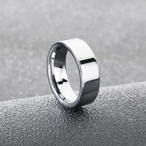 Macro shot of 8mm silver polished stainless steel ring on textured dark background