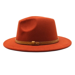 Detail of the orange wool fedora hat featuring a snake-textured brown leather belt