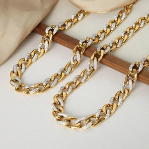 Elegant gold cuban chain necklace with rhinestones on silk and wooden frame background