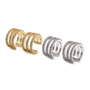 Chic multi-layered gold and silver ear cuffs with sparkling crystals on white background
