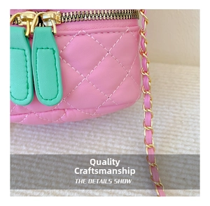 Macro shot of pink quilted leather with mint green zipper and gold chain hardware