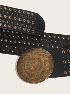 Detail of vintage PU leather belt with bronze circular buckle and metal eyelets